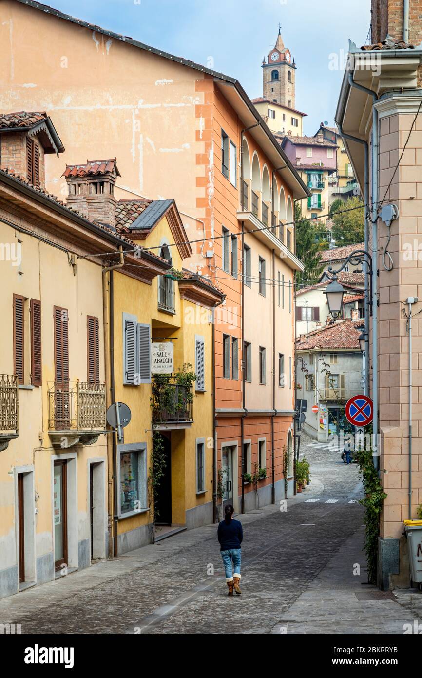 Woman walks down cobbled street in Monforte d'Alba, Piemonte, Italy Stock Photo