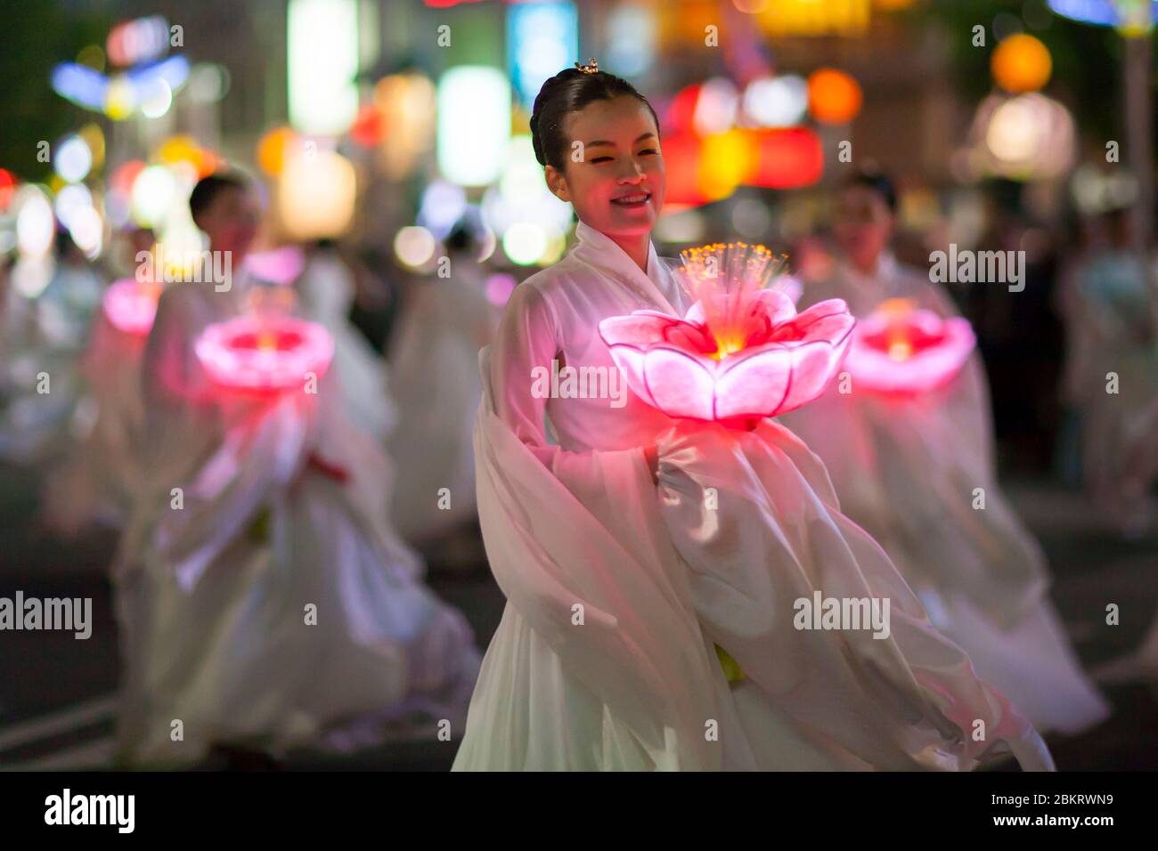 South Korea, Seoul, Jongno district, Buddha's birthday celebrations, young woman in white traditional costume named Hanbok in Korean, carrying a lantern in the shape of a bright lotus Stock Photo
