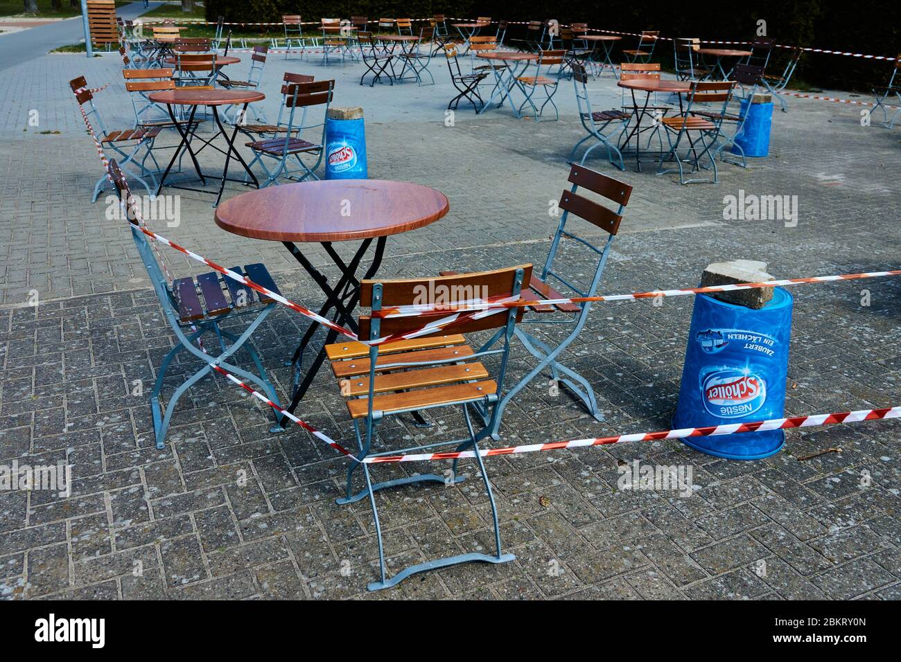 Gifhorn, Germany, April 14., 2020: Tables and chairs in an outdoor restaurant locked due to the Corona crisis Stock Photo