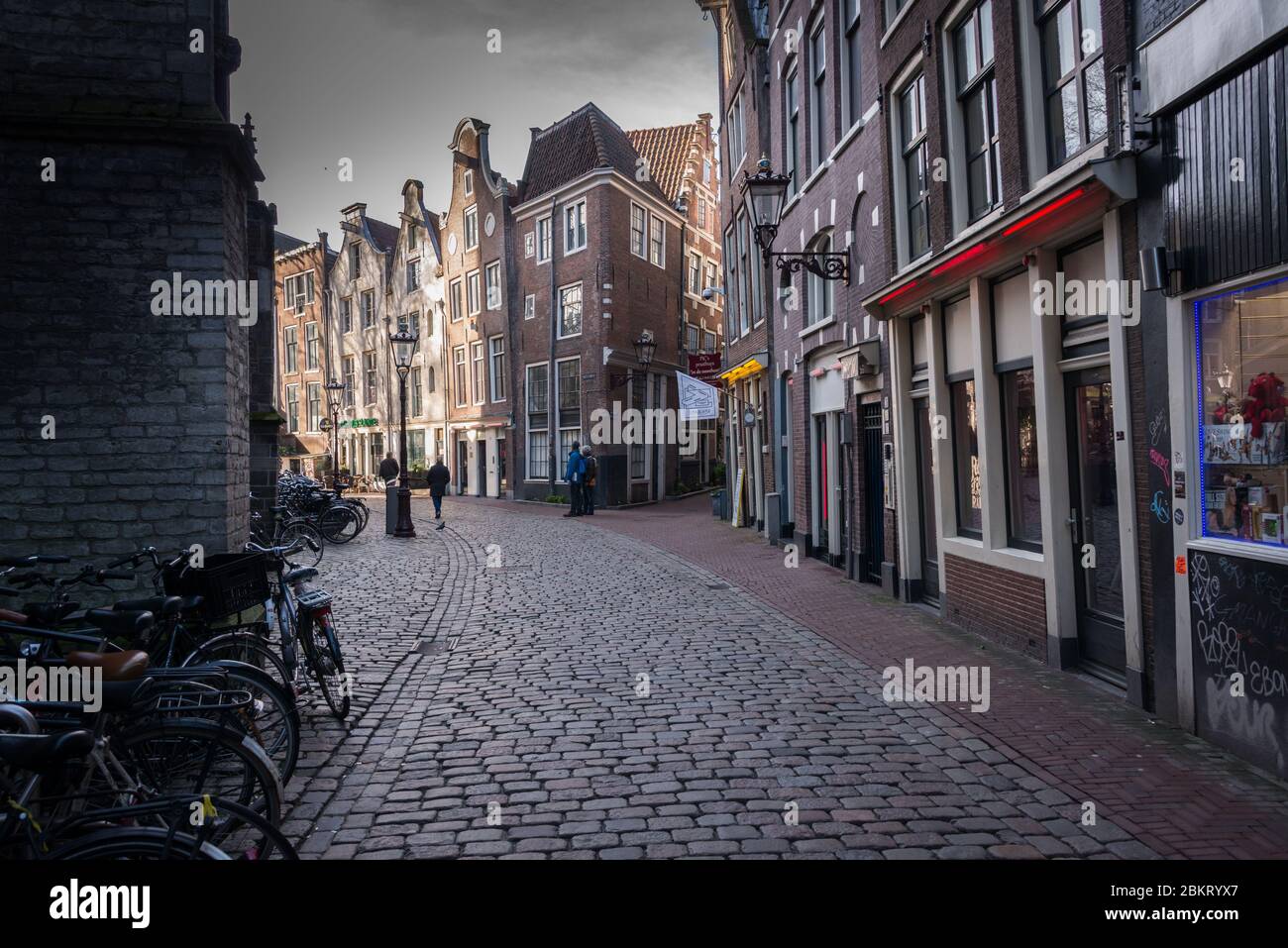 Amsterdam, Netherlands - February 2016:, Crooked house and cobbled streets in the Red Light Area Stock Photo
