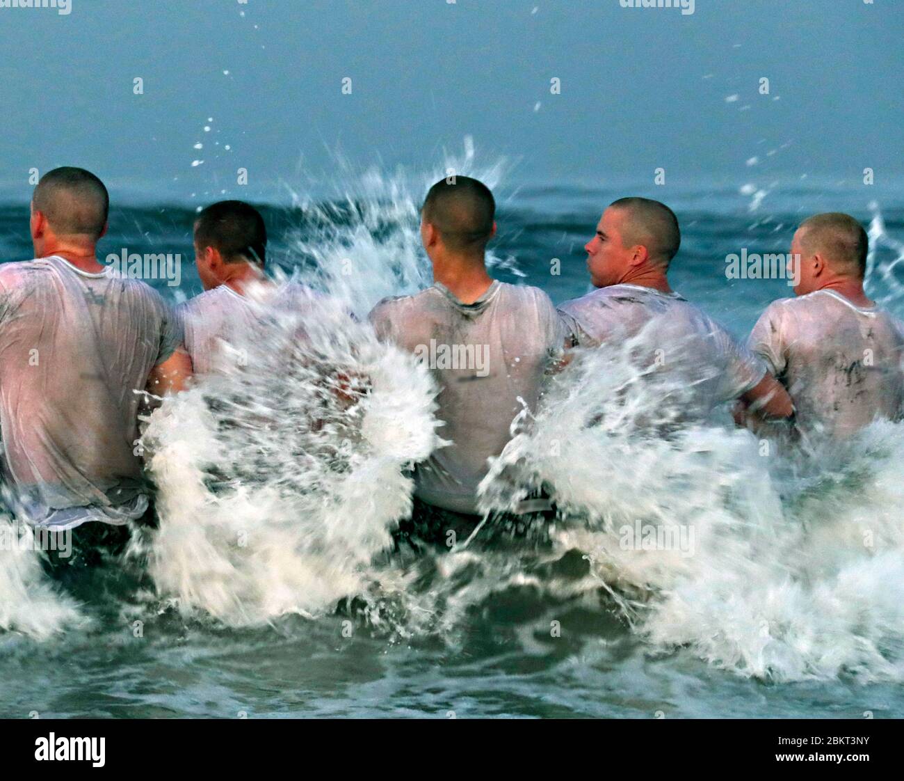 U.S. Navy SEAL candidates during the surf immersion test, part of the Basic Underwater Demolition/SEAL training at the Naval Special Warfare Center May 4, 2020 in Coronado, California. The selection-and-assessment training was paused due to the COVID-19, coronavirus pandemic and has now been restarted implementation of medical guidelines. Stock Photo