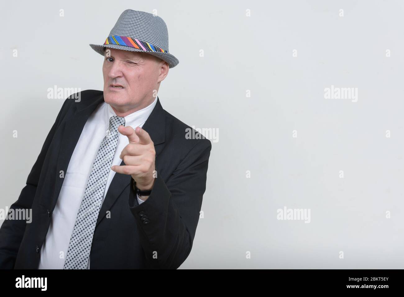 Mature winking man pointing hi-res stock photography and images - Alamy
