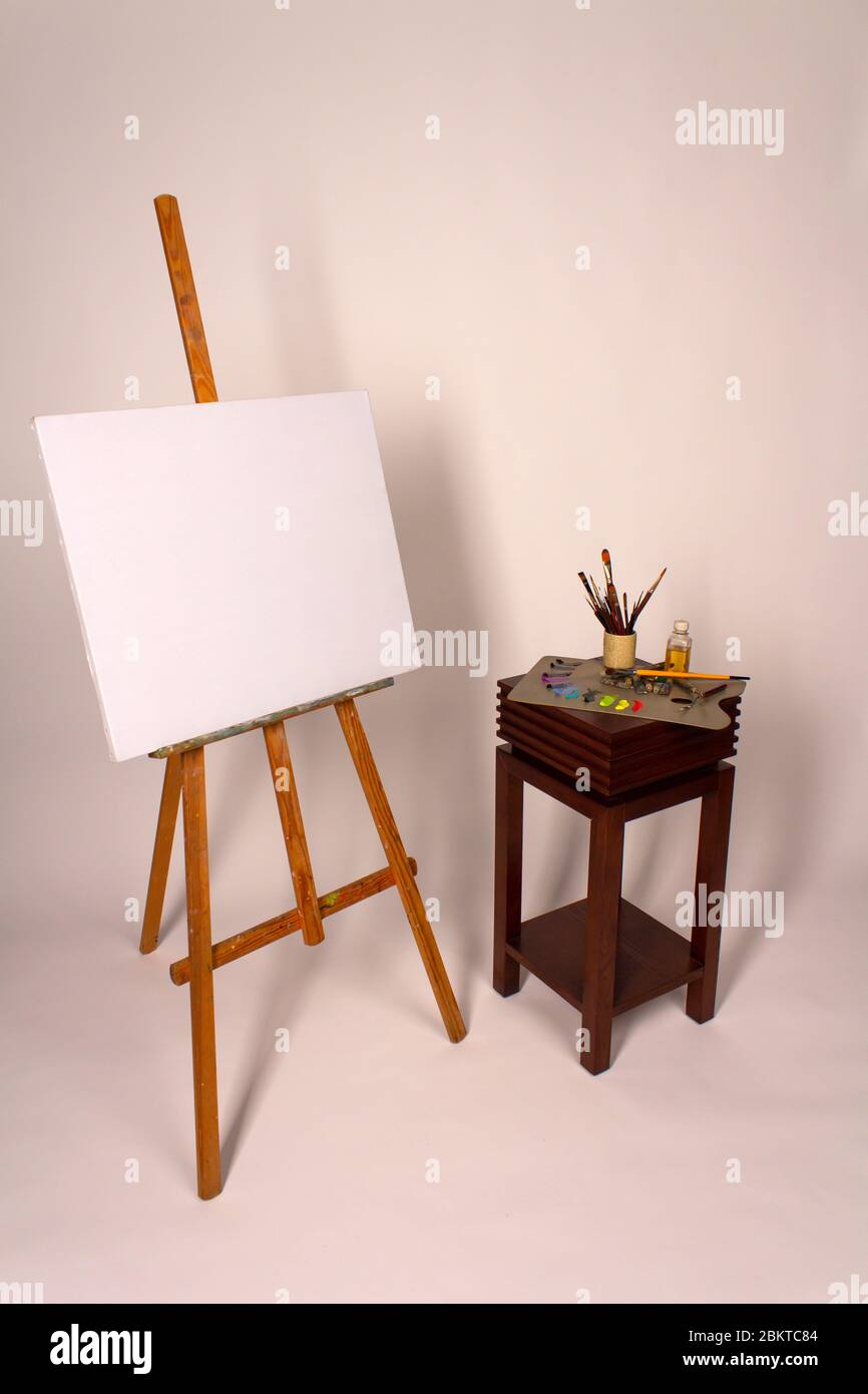 Oil Painting. Easel And Blank Canvas. Palette With Paints And Brushes.  Squeeze Out Oil Paints On A Palette And Pieces Of Canvas. Clean Canvas With  Copy Space Close Up. Stock Photo, Picture