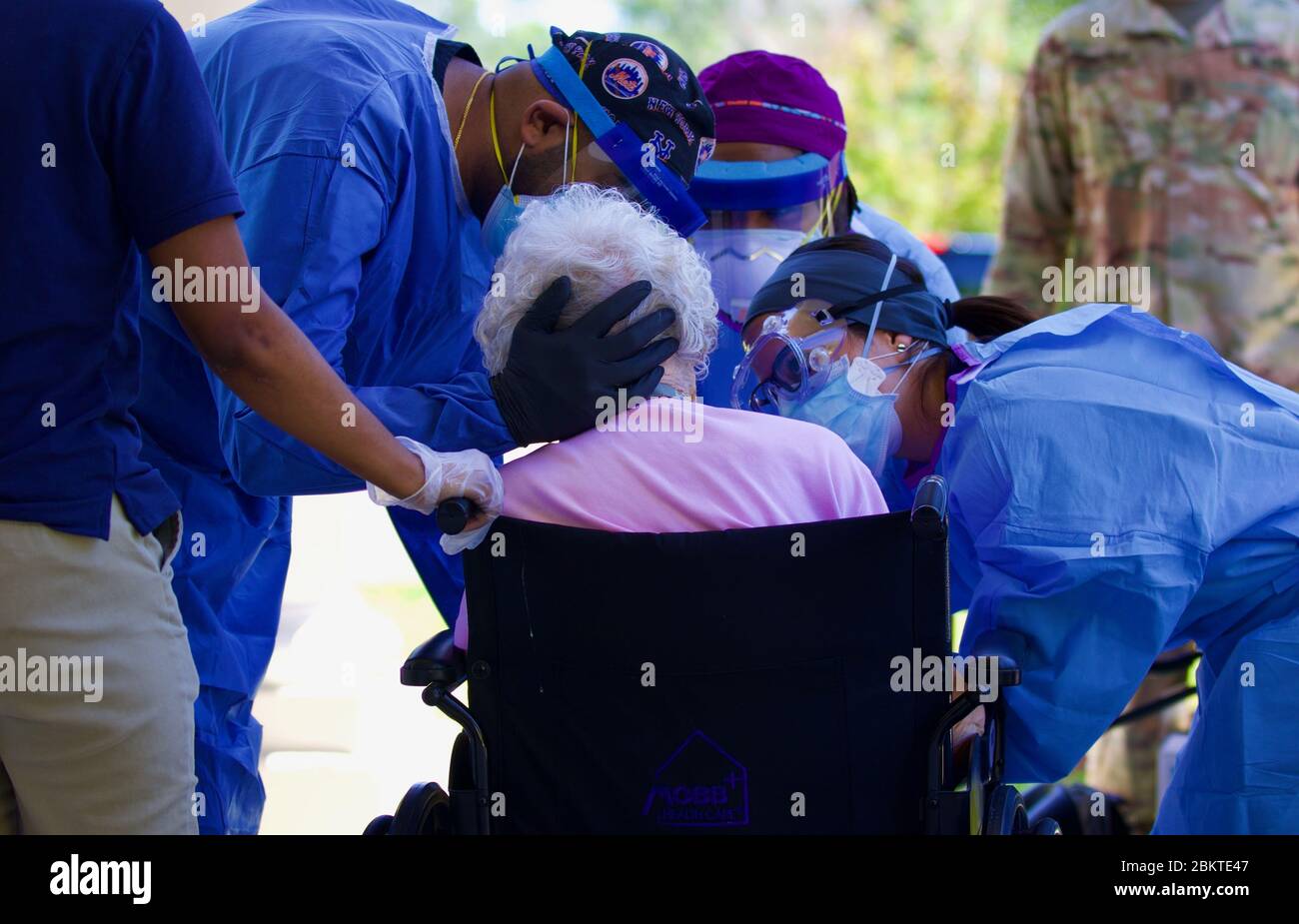 Registered nurses with the Florida Department of Health perform a COVID-19, coronavirus specimen collection on a patient at a Northeast Florida nursing home May 1, 2020 in St. Augustine, Florida. Stock Photo