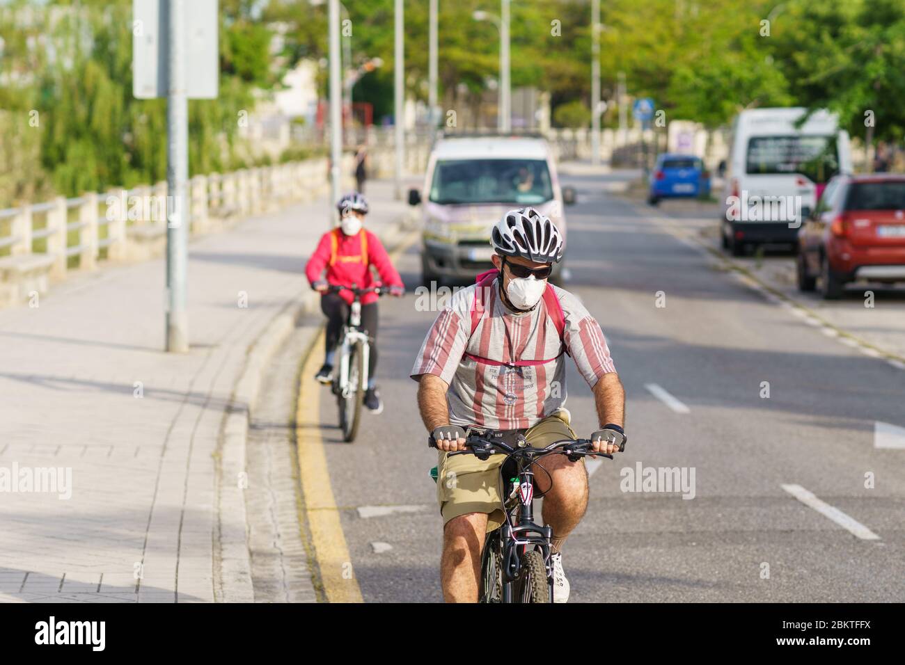 People riding bikes, wearing masks, as protection from the Covid-19 ...