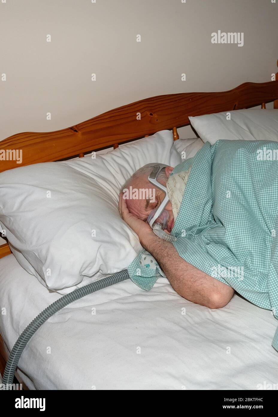 May 2020 Mature man fast asleep wearing the mask of a CPAP sleep