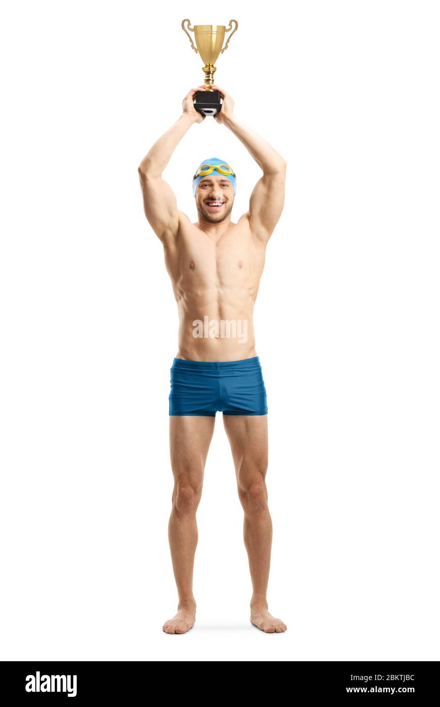 Full length portrait of an athletic male swimmer lifting a gold trophy cup isolated on white background Stock Photo