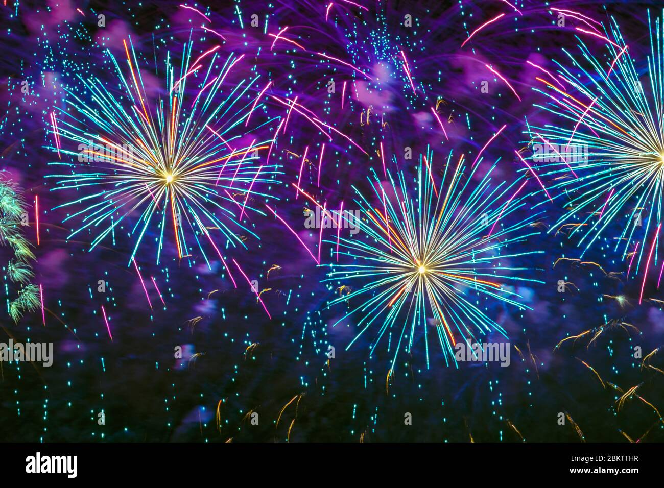 Holiday Fireworks with sparks, colored smoke and bright nebula on black sky as stars, universe, comets Stock Photo