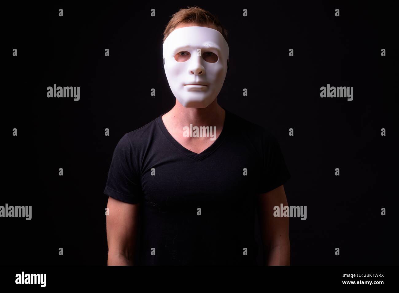 Portrait of young man wearing white mask Stock Photo