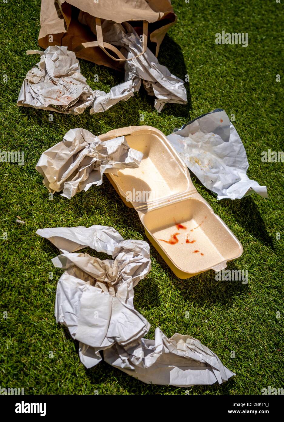 Discarded Fast Food Wrappers on Ground Stock Photo