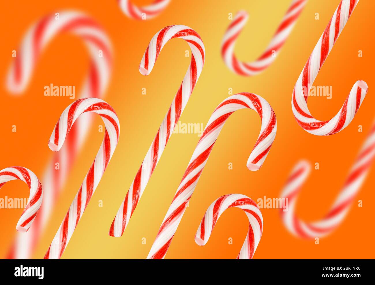 Candy cane pattern isolated on white background. Red and yellowstriped caramel Lollipop. Christmas background. The concept of a candy store. Stock Photo