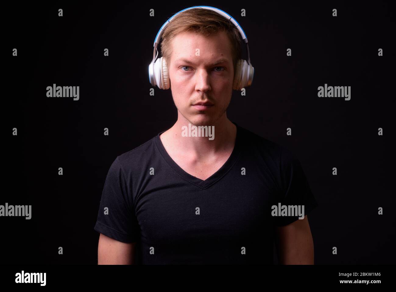 Portrait of young handsome man listening to music Stock Photo
