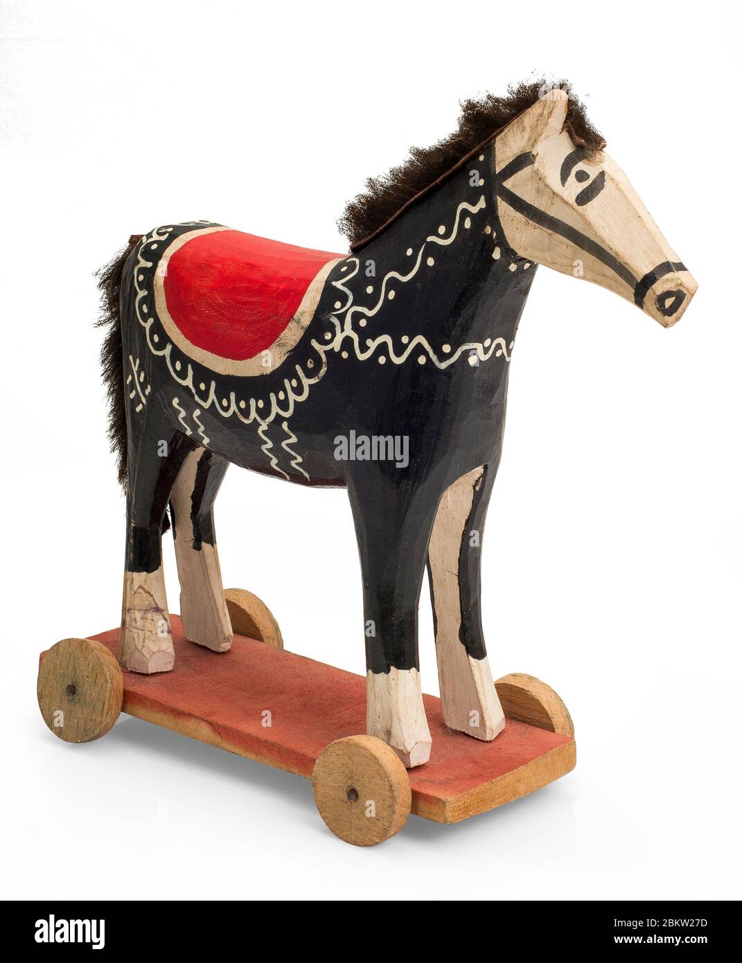 A black wooden horse on wheels, croatian traditional toy Stock Photo