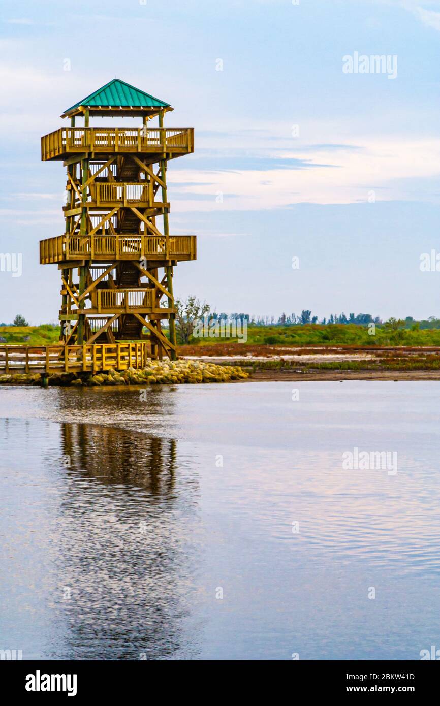 Observation tower reflects in pond at sunset at Robinson Preserve in Bradenton Florida Stock Photo