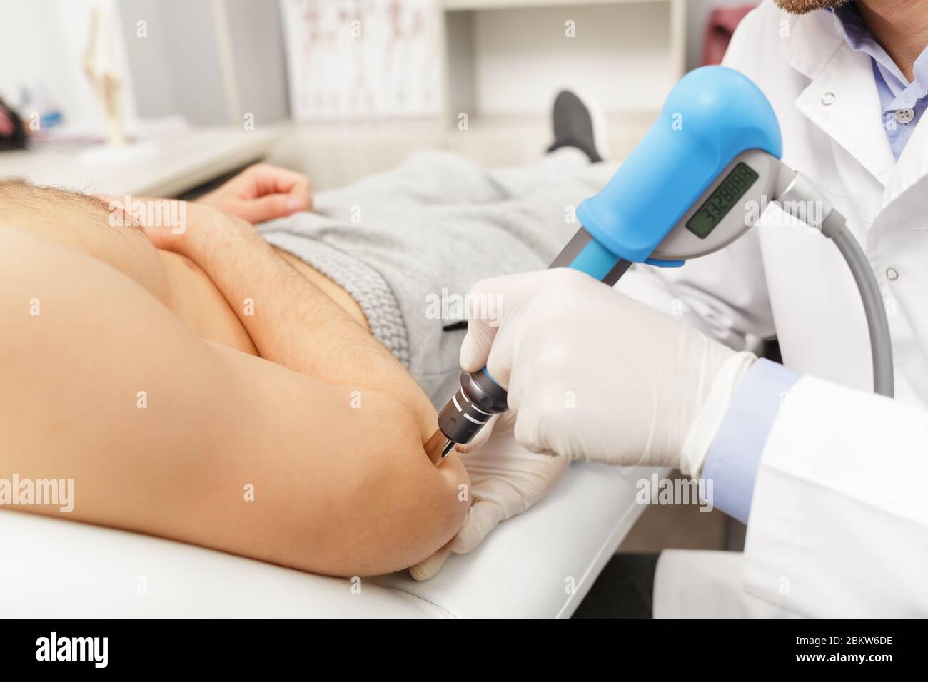 Extracorporeal Shockwave Therapy ESWT.Effective non-surgical  treatment.Physical therapy for lower back with shock waves.Pain relief,  normalization and Stock Photo - Alamy