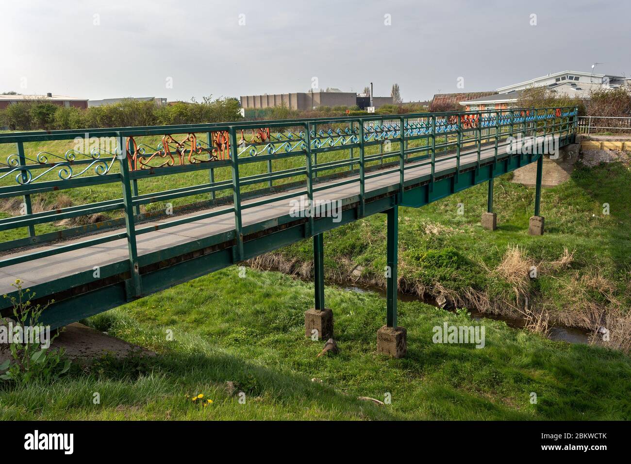Metal footbridge over River Birket, leading from Wirral Circular Trail to Kingsway Academy, Moreton, Wirral. Stock Photo