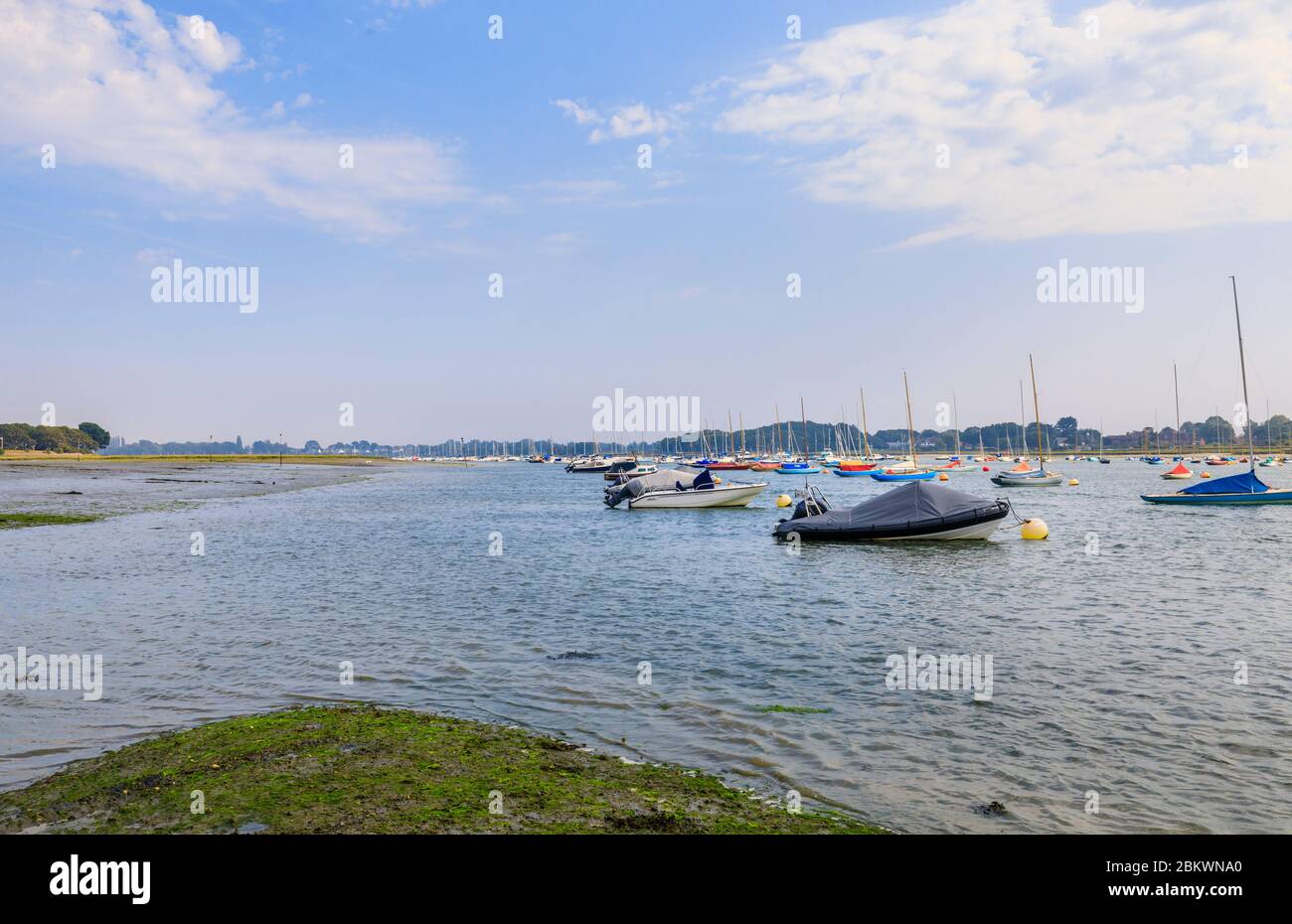 Sailing boats moored by the Smugglers Lane and Ferry Hard intertidal saltmarsh areas at low tide