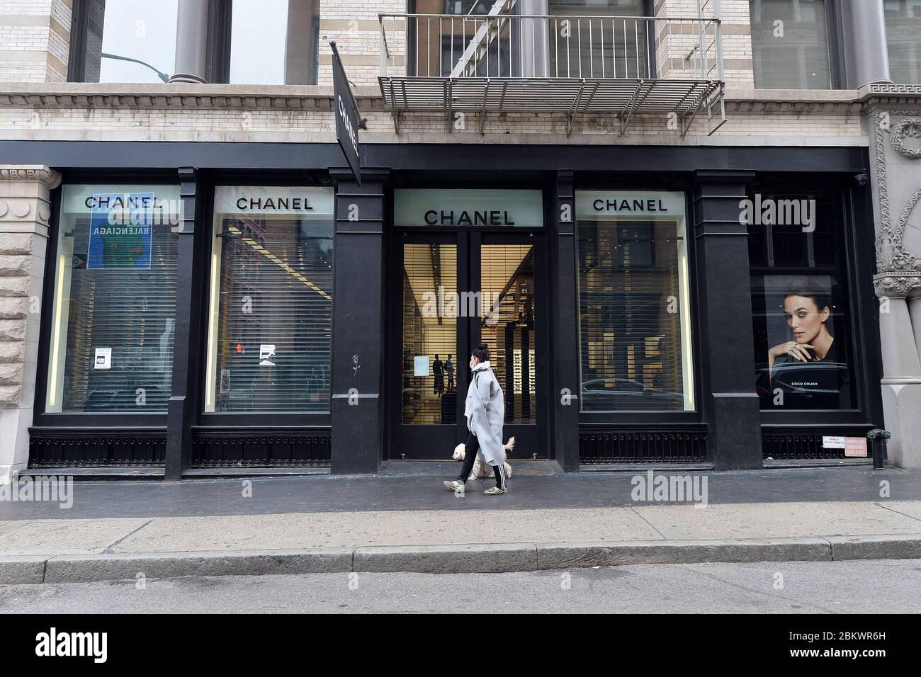 A woman walks past Chanel store which remains close due tothe COVID-19  pandemic, in the Soho neighborhood of New York City, NY, May 5, 2020. The  usually bustling and vibrant neighborhood lined