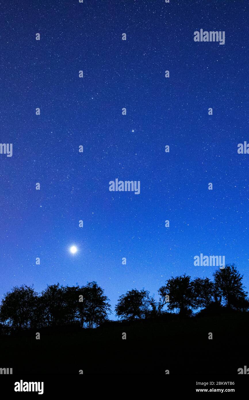 Multitude of stars in night sky with Venus at its brightest stage this year in prominent view over southern England, United Kingdom Stock Photo