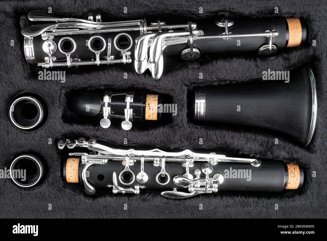 black clarinet  silver wooden woodwind musical brass instrument in pieces parts in music case. classic orchestra symphony background. Stock Photo