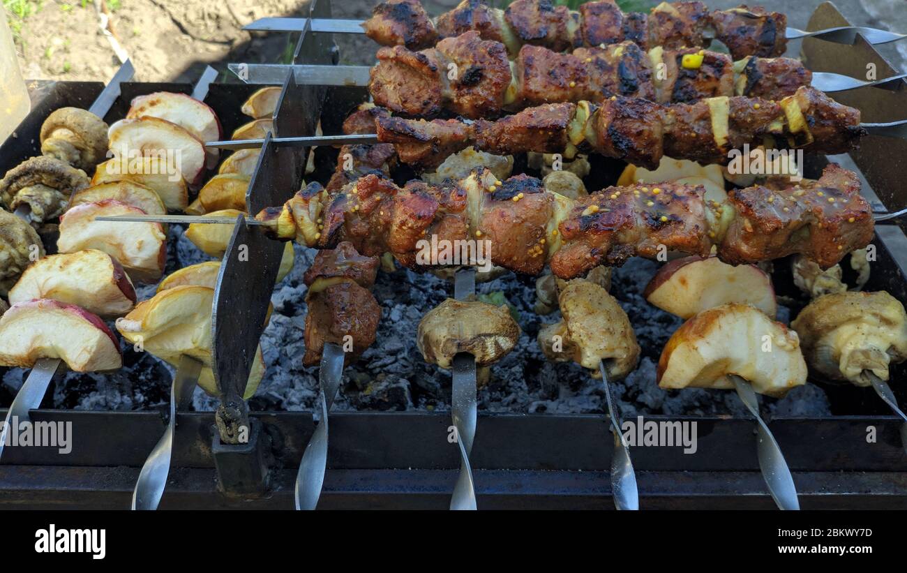 Shish kebab of meat skewered on a grill close-up outdoors Stock Photo -  Alamy