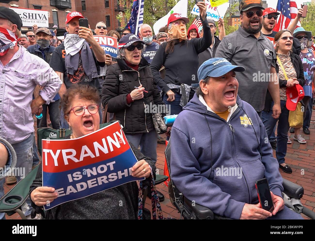May 4, 2020, Boston, Massachusetts USA: Anti lock down protesters on wheel chairs shouting in support to end lock down during Liberty rally at Massachusetts State House in Boston. Large crowd of anti lock down protesters gather outside of the State House to protest Massachusetts Governor Charlie Baker's stay-at-home emergency order at Liberty rally in Boston. Stock Photo