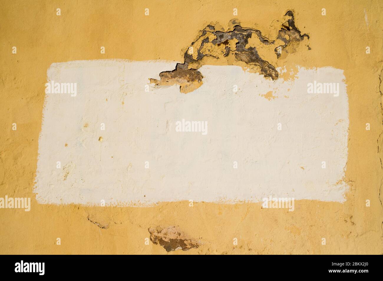 A painted area on a stucco background creating a frame with copy space. Stock Photo
