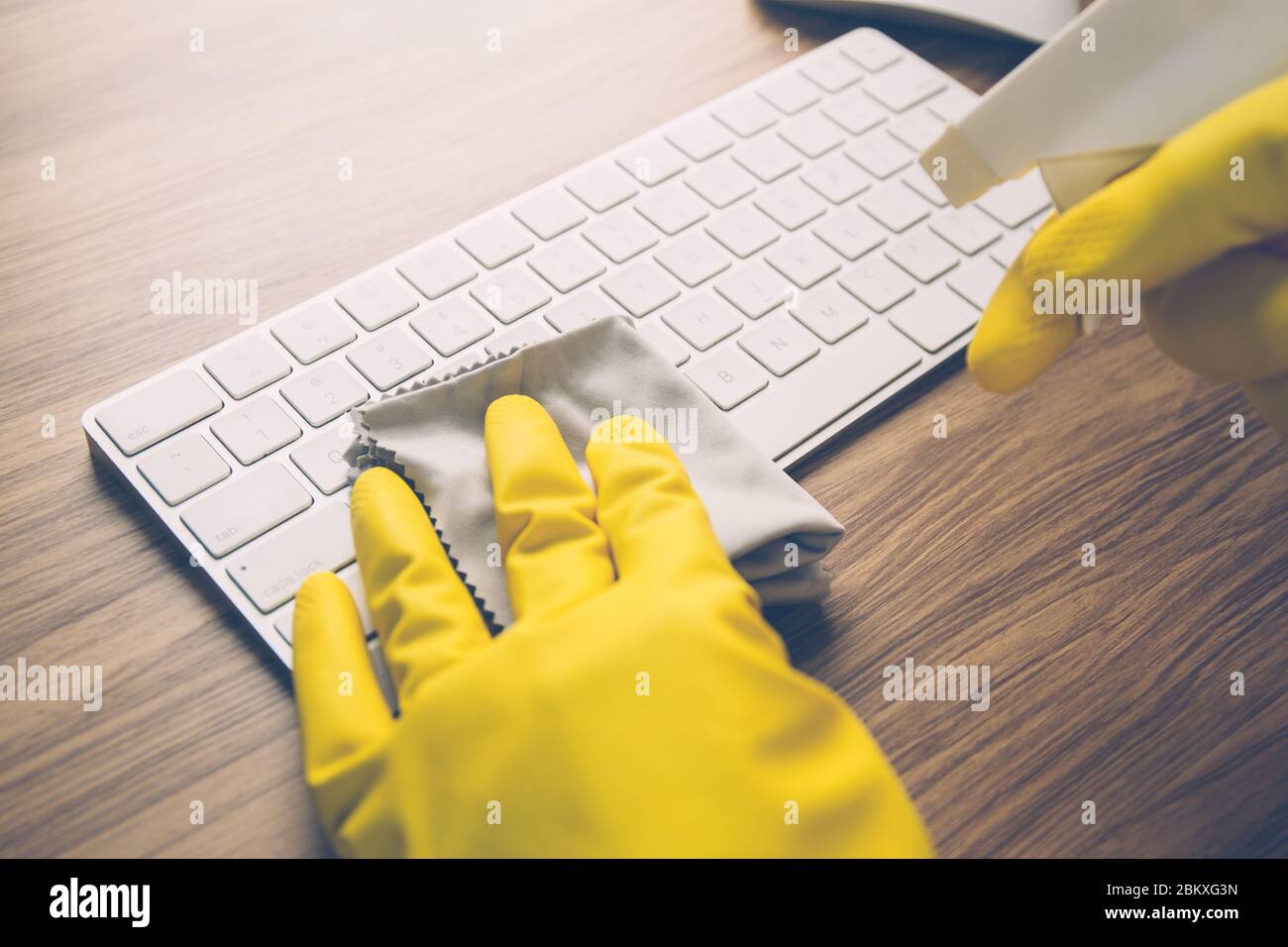 Hand of man cleaning keyboard computer with antibacterial for protect