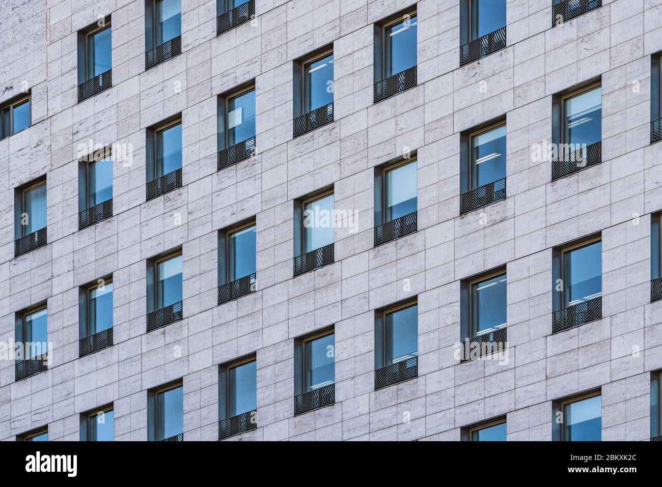 Rows of windows of a business building built in roman travertine marble Stock Photo