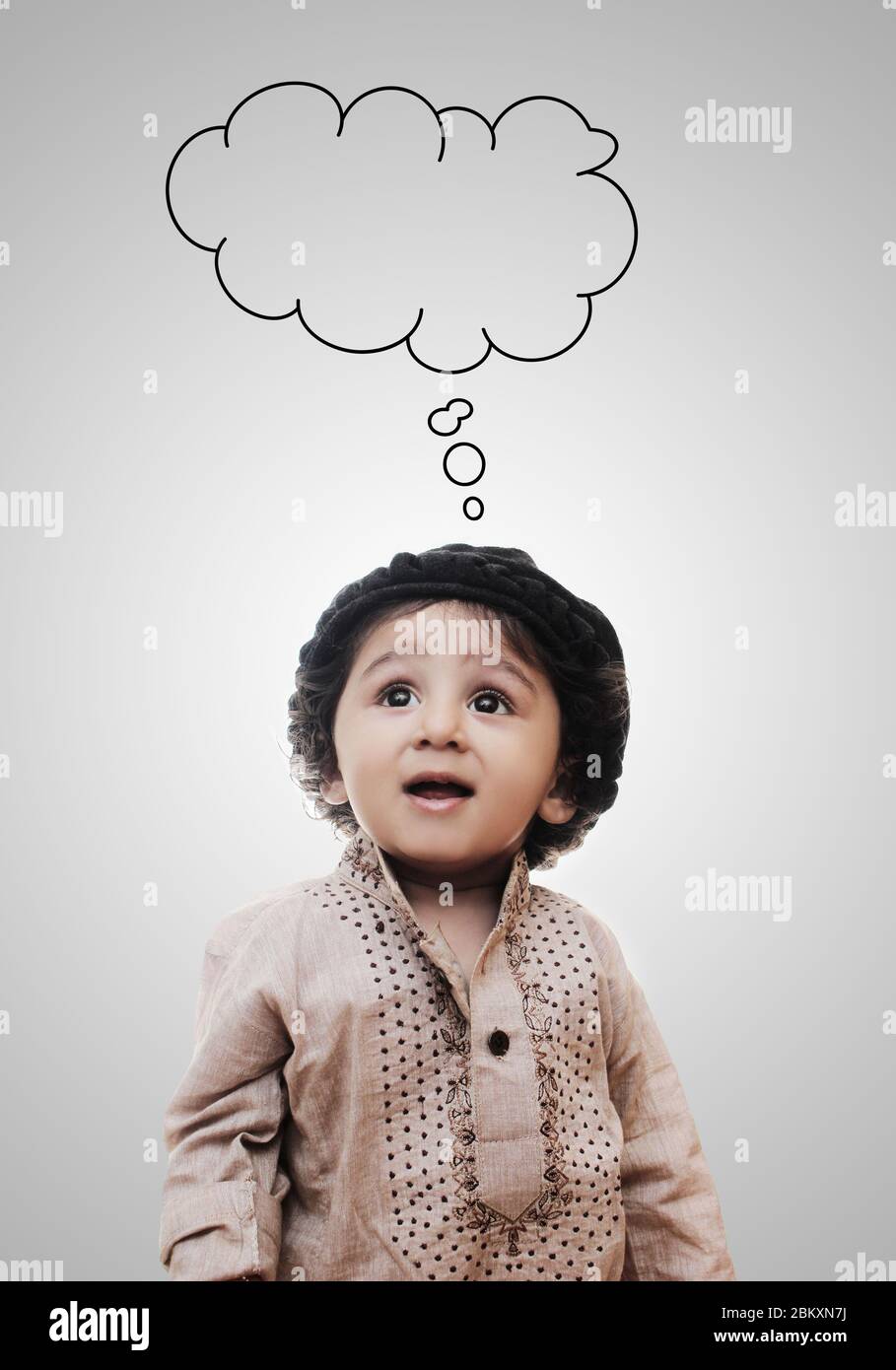Adorable Intelligent Little Caucasian Boy Thinking Cloud While Standing Before A White Background; Thinking Process With Chalk Board Stock Photo