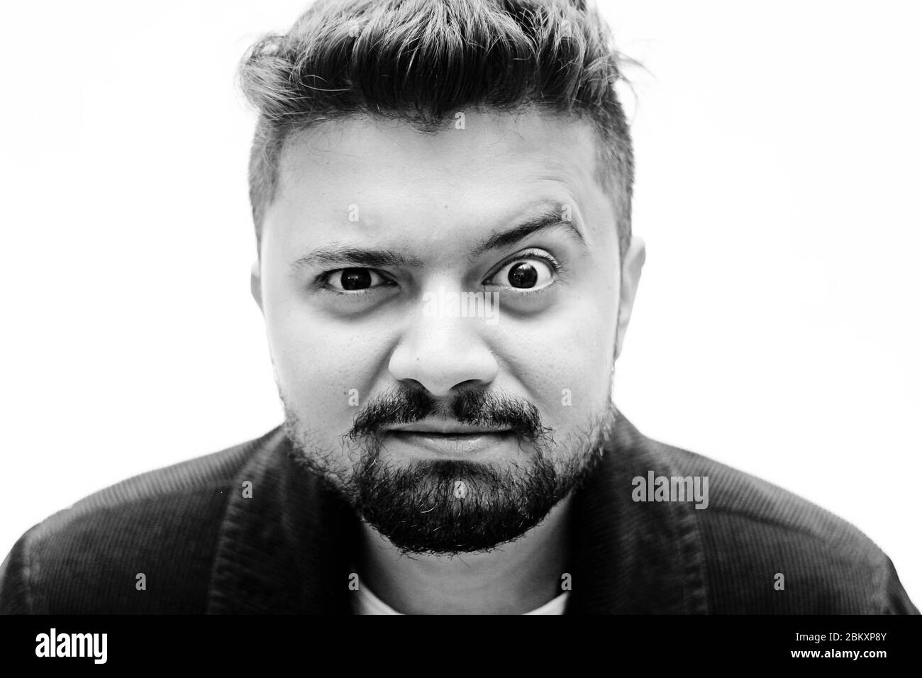 Portrait Of A Young Caucasian Man Baffled Facial Expression isolated on white background Stock Photo