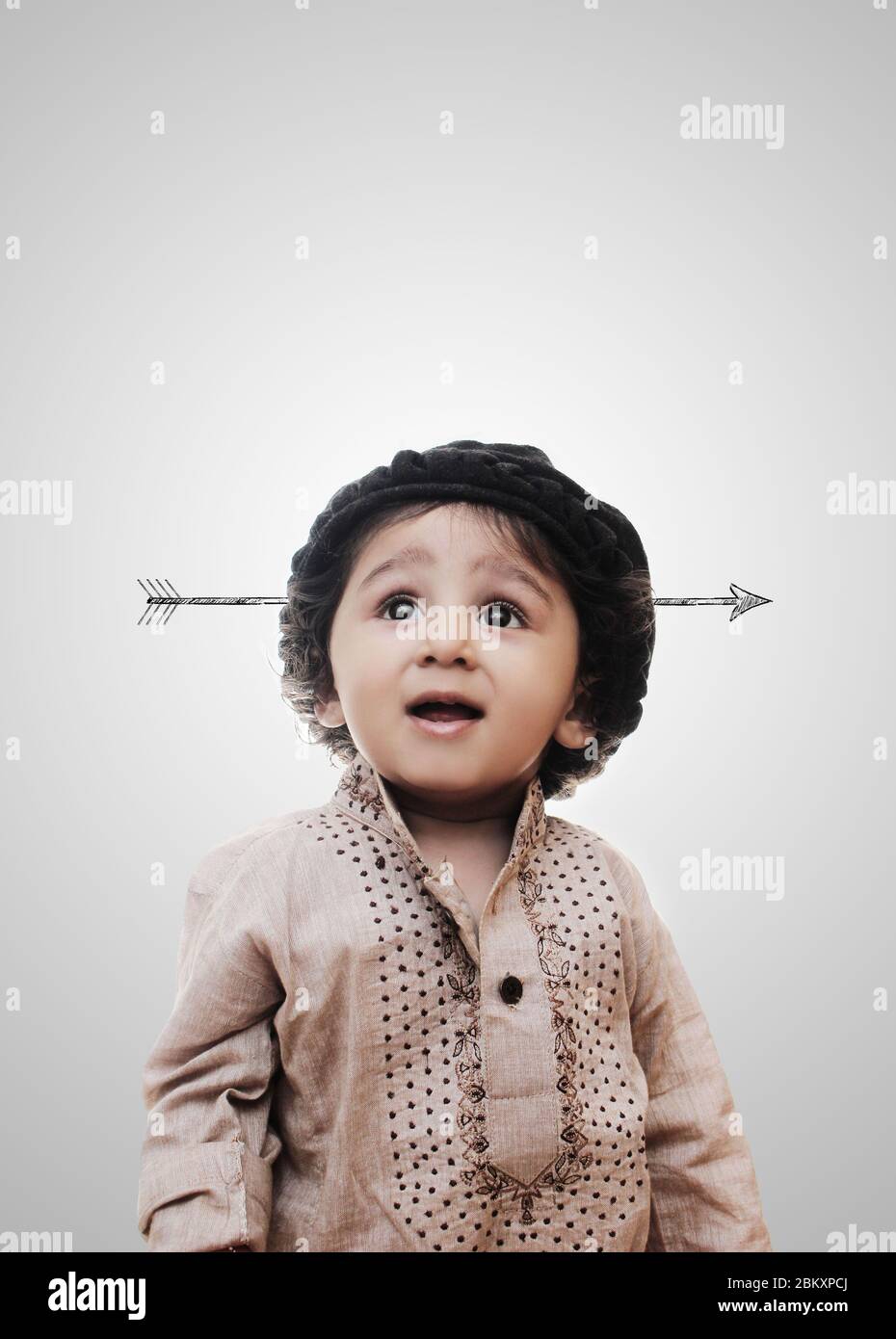 Adorable Little Boy Thinking With The Arrow In Head While Standing Before A White Background - Little Boy Thinking Stock Photo