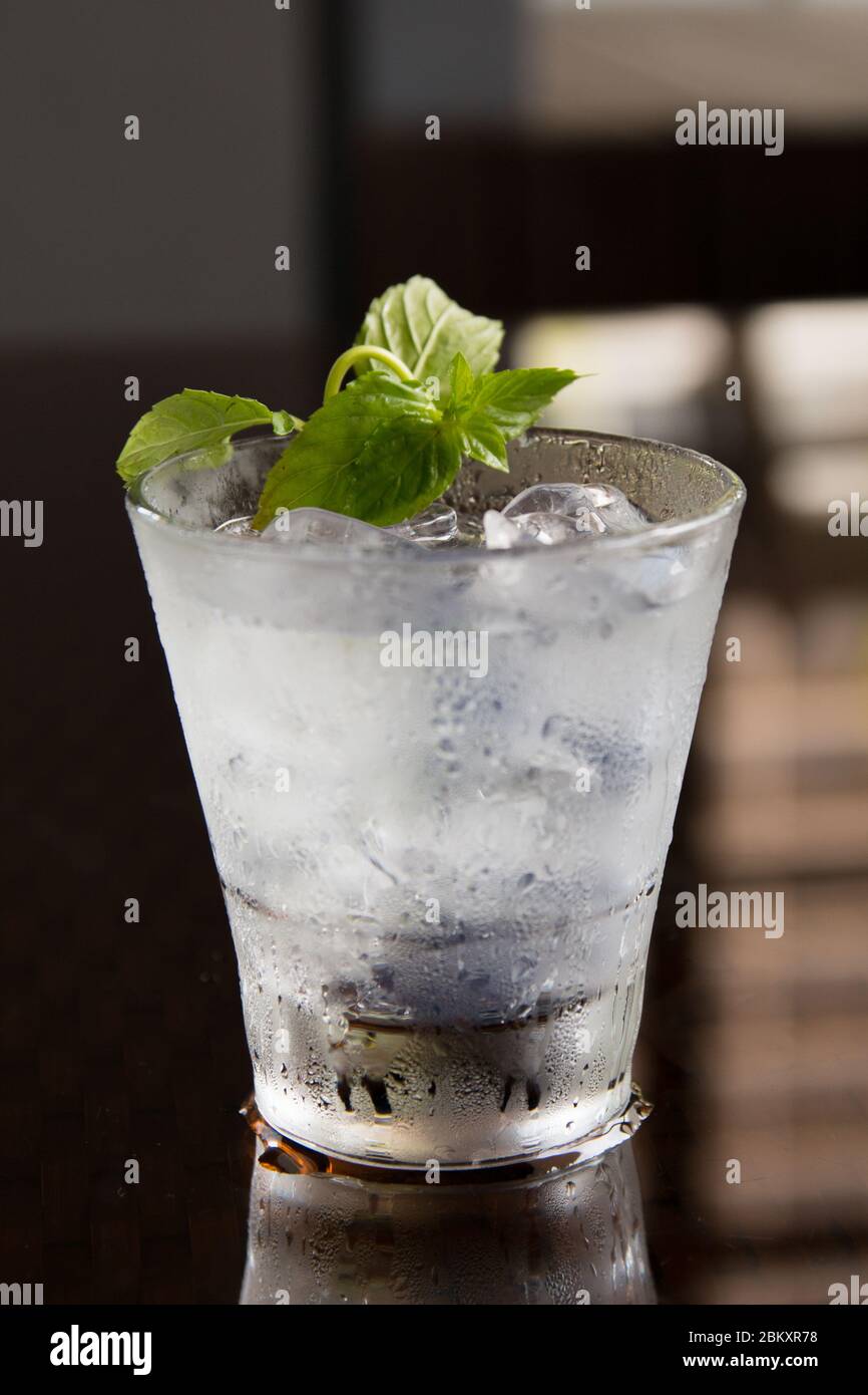 Fresh mojito on a dark background with mint leave on top. Stock Photo