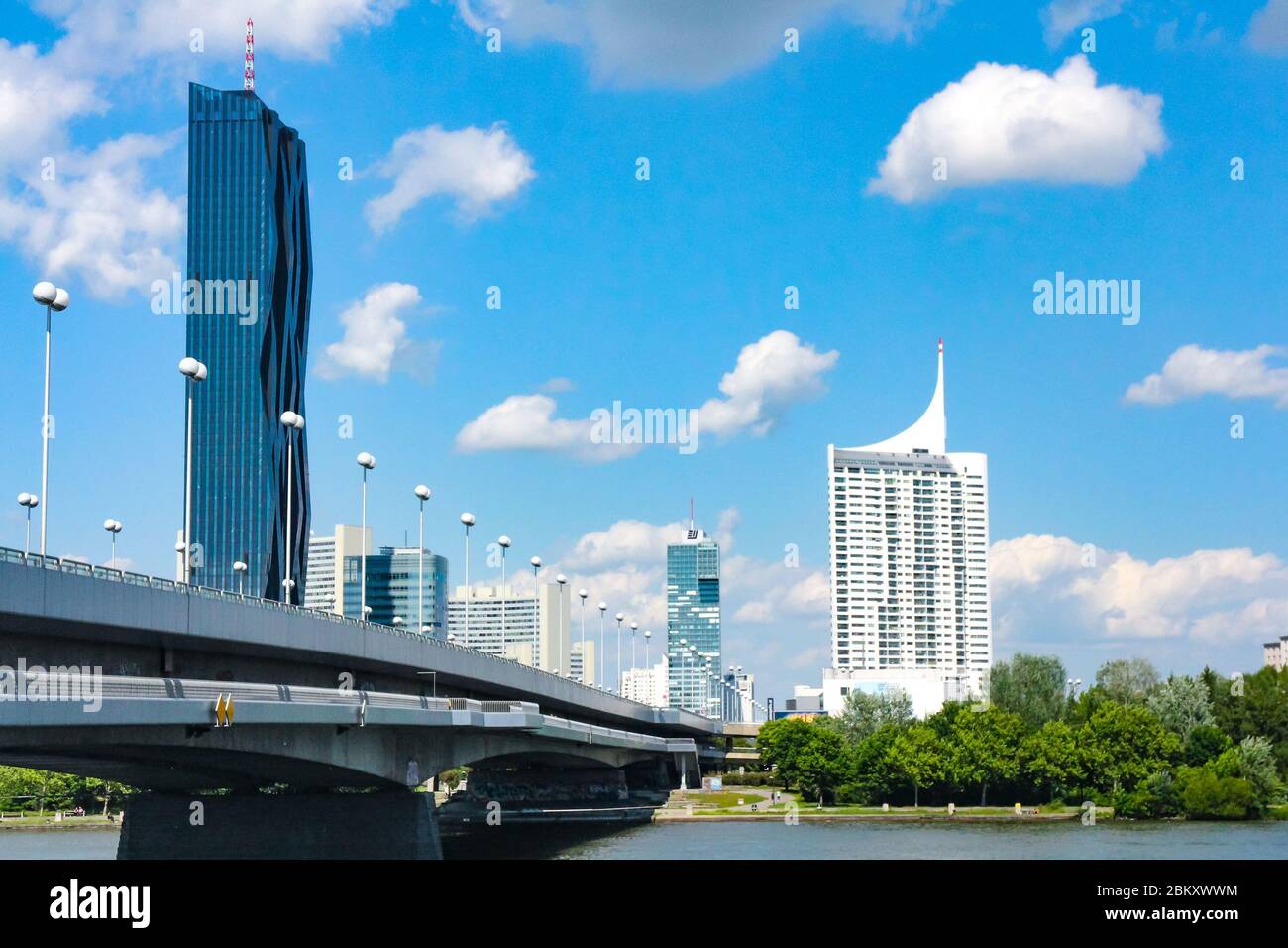 View of Reichsbrücke Bridge and skyscrapers on Donauinsel (Danube Island), an artificial island of the Danube river in Vienna, capital of Austria. Stock Photo