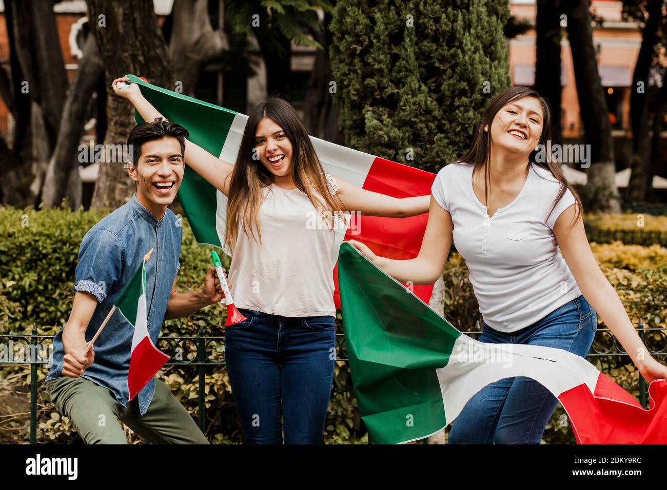 Mexican people cheering with flag of Mexico, Viva Mexico in Mexican independence day Stock Photo