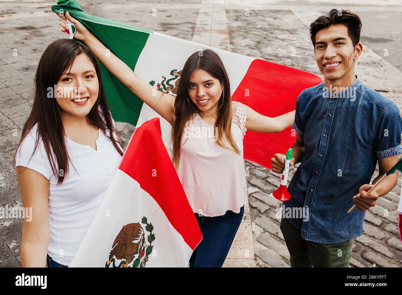 Mexican people cheering with flag of Mexico, Viva Mexico in Mexican independence day Stock Photo