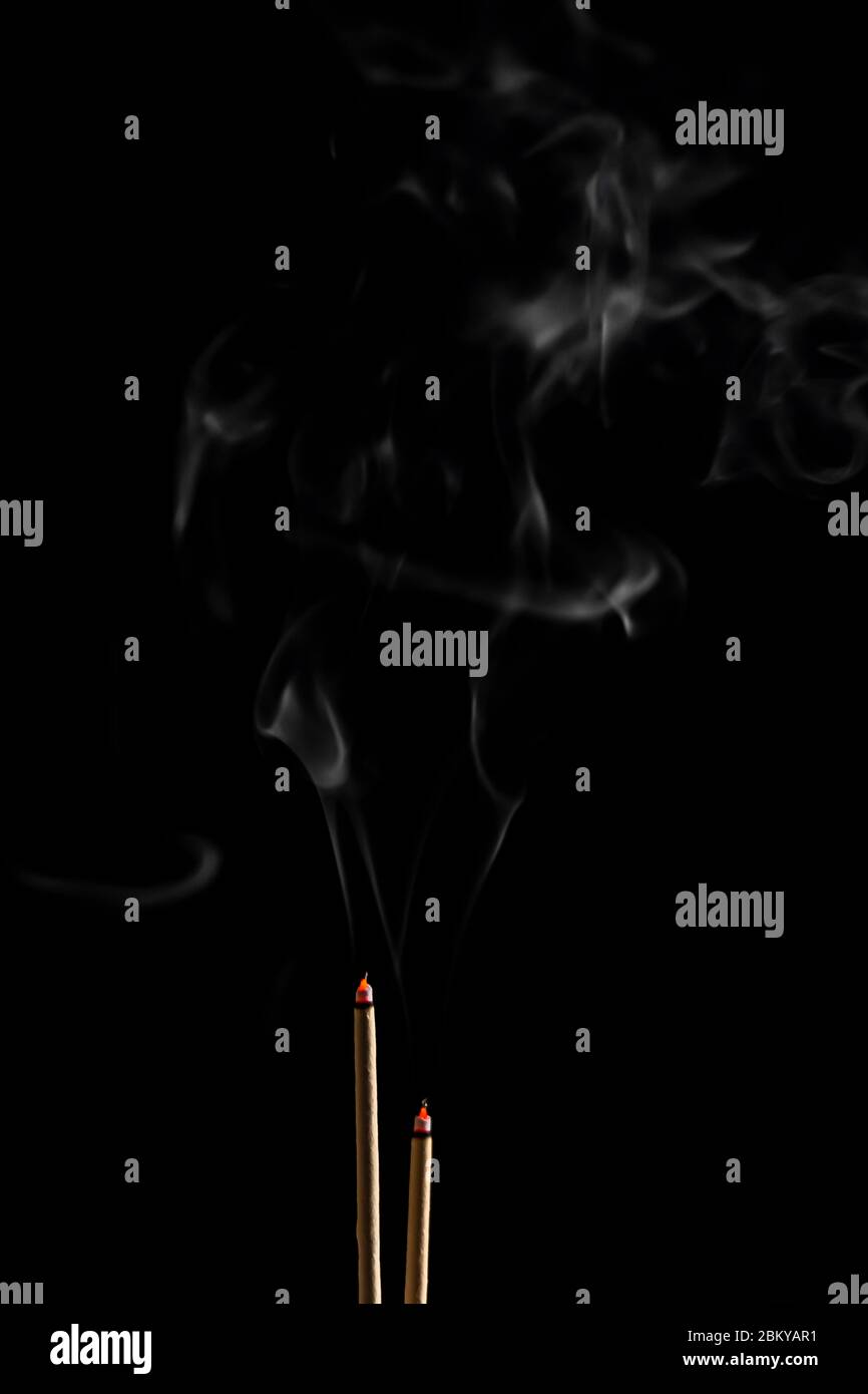 Incense sticks and incense stick smoke on black backgrond with white ...