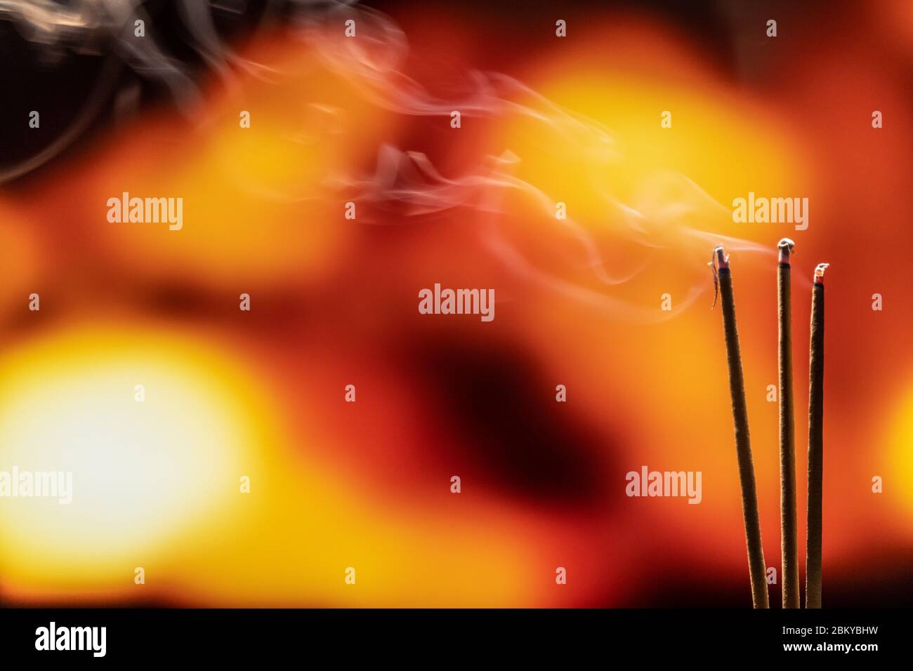 Burning Incense Sticks with smoke, joss sticks burning at a vintage