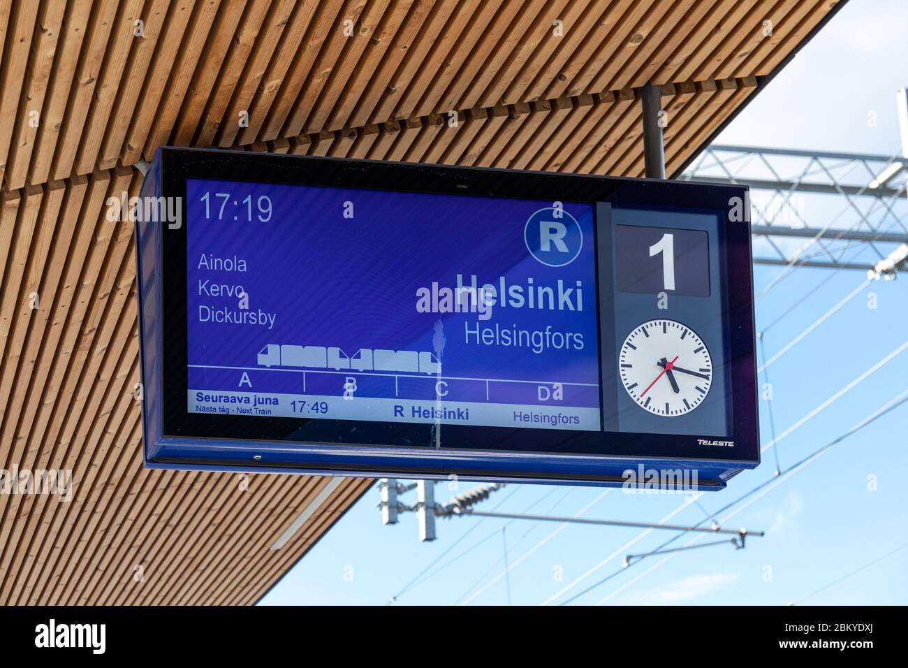 Passenger information display at Järvenpää railway station in Finland. Next R-train from Riihimäki to Helsinki. Stock Photo