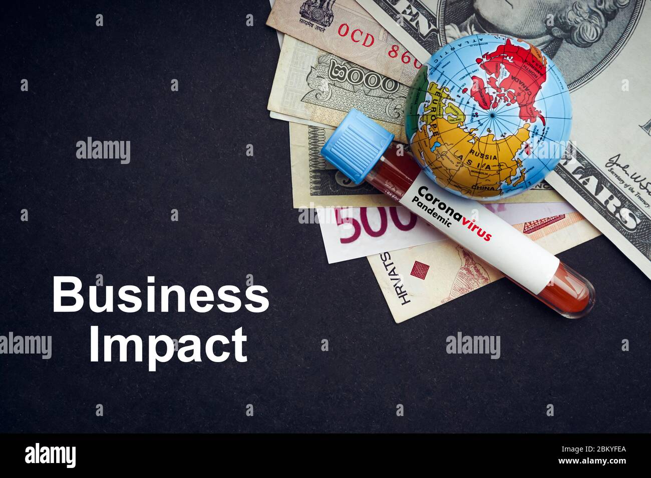 CORONAVIRUS BUSINESS IMPACT text with currency banknotes, world globe and blood test vacuum tube on black background. Covid-19 or Coronavirus Concept Stock Photo