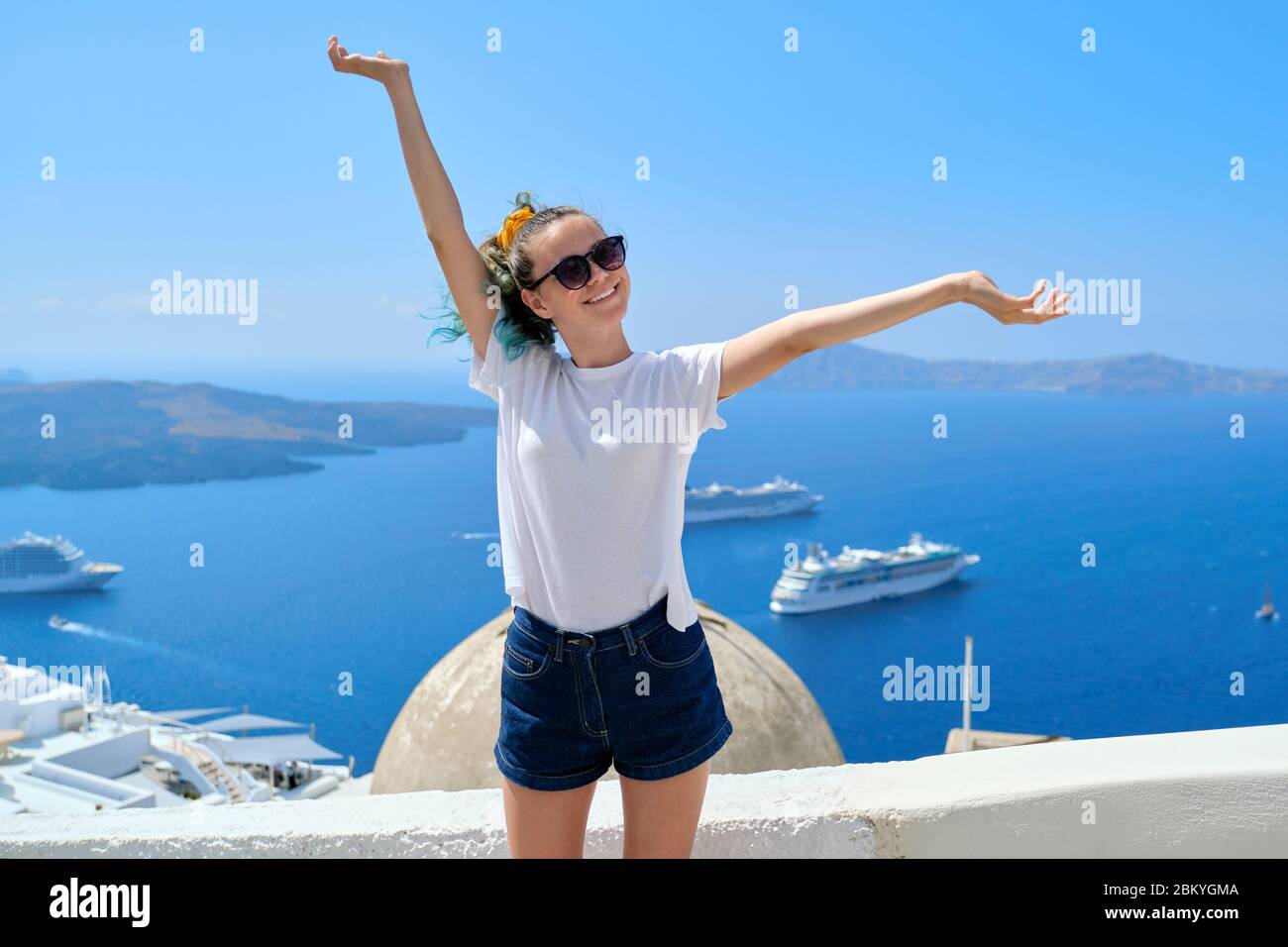 Teenager girl smiling, background sea landscape with white cruise liners Stock Photo