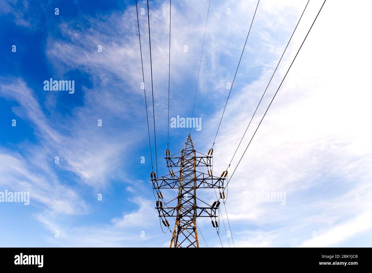 electrical high voltage tower on a blue sky background Stock Photo - Alamy