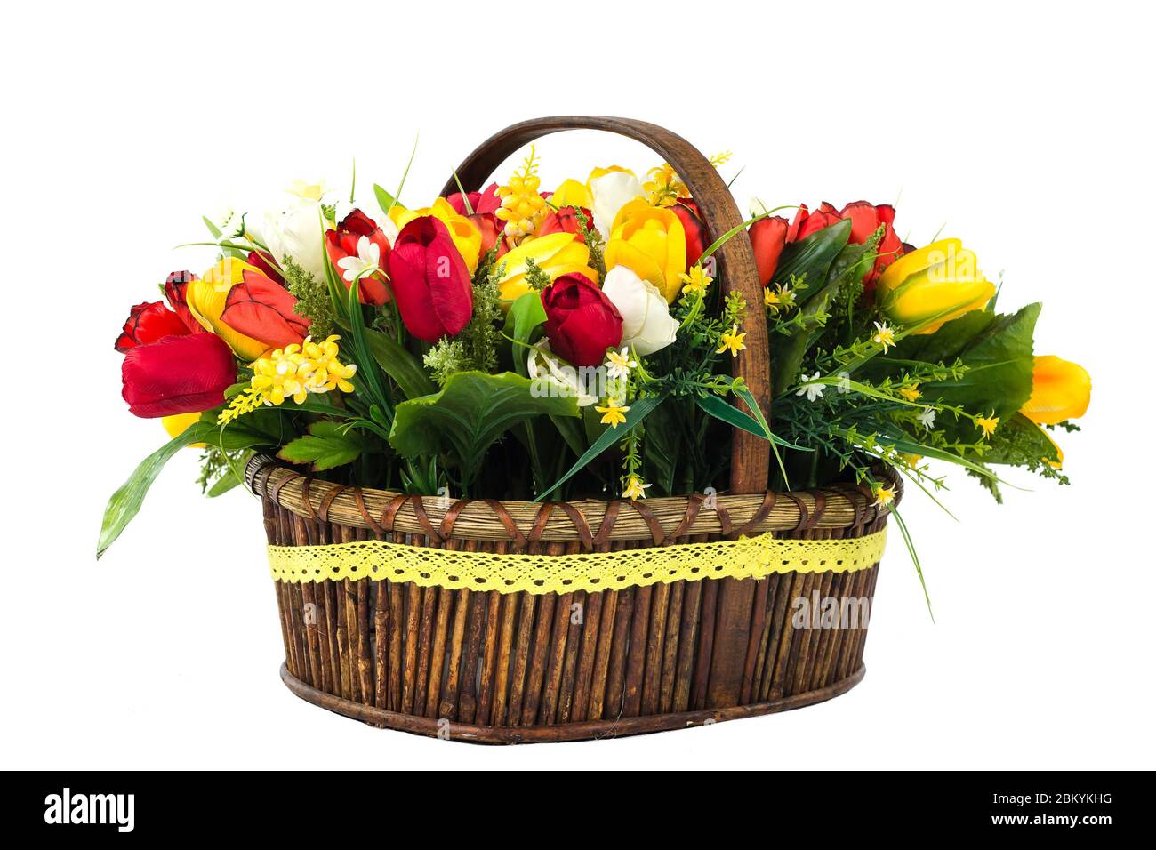 bouquet of yellow and red tulips with wild flowers in a wicker basket ...