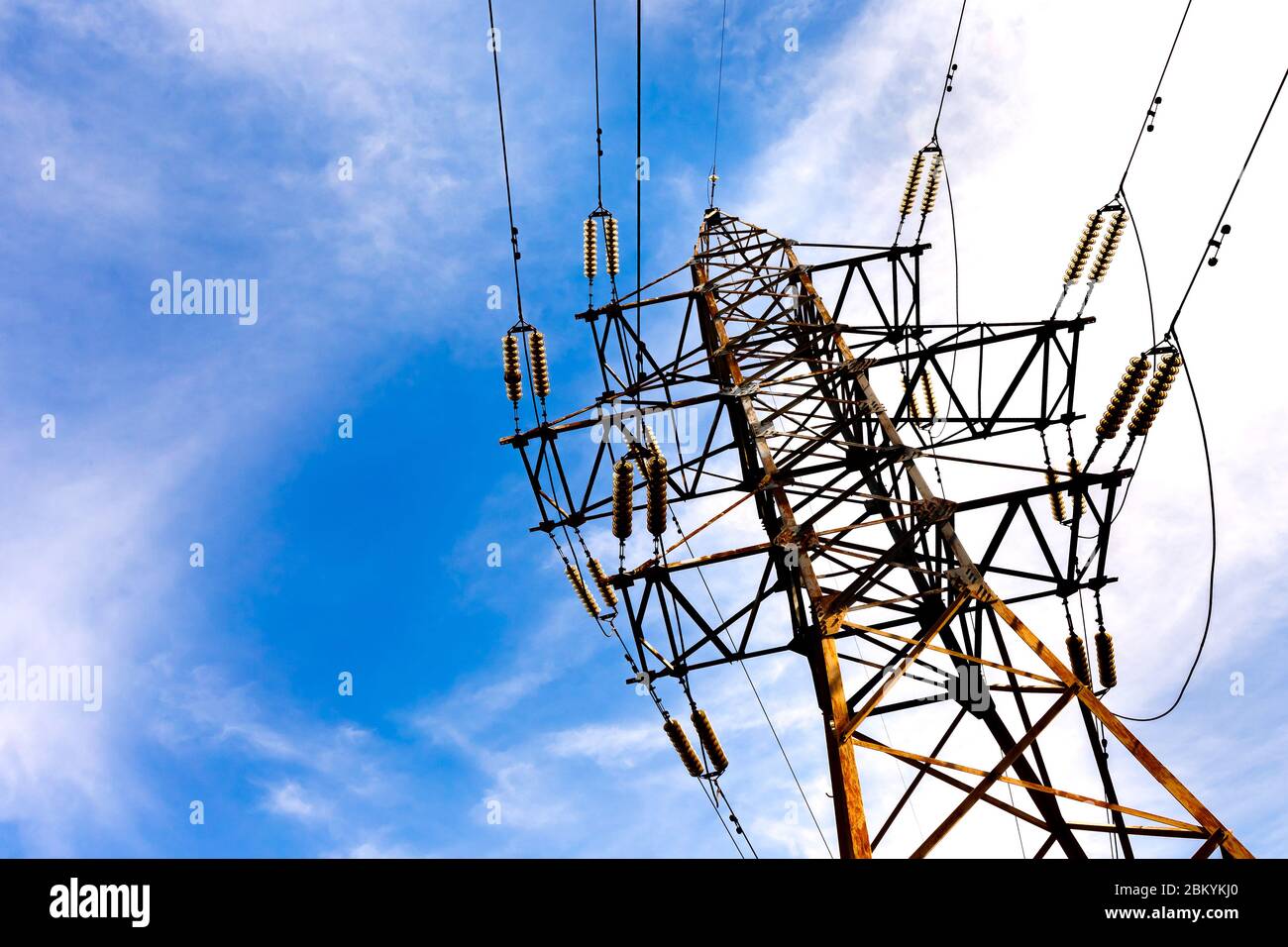 electrical high voltage tower on a blue sky background Stock Photo - Alamy