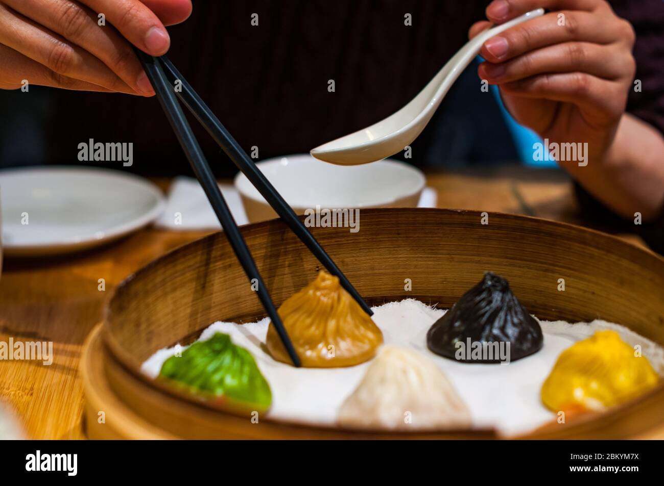 A Chinese lady picks up a foie gras flavoured gourmet xiaolongbao soup