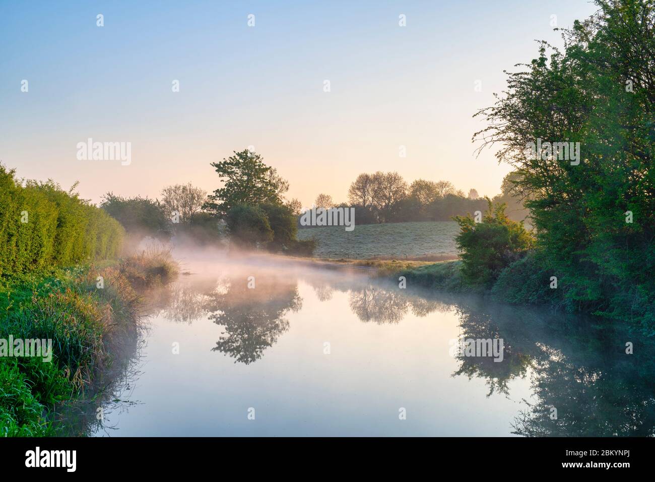 Mist on the oxford canal on a spring morning at sunrise. Near Somerton, Oxfordshire, England Stock Photo