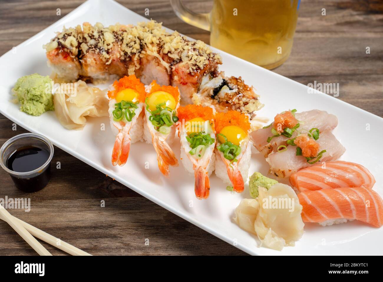 Platter of fresh sushi with shrimp boats, sushi roll, tuna and salmon