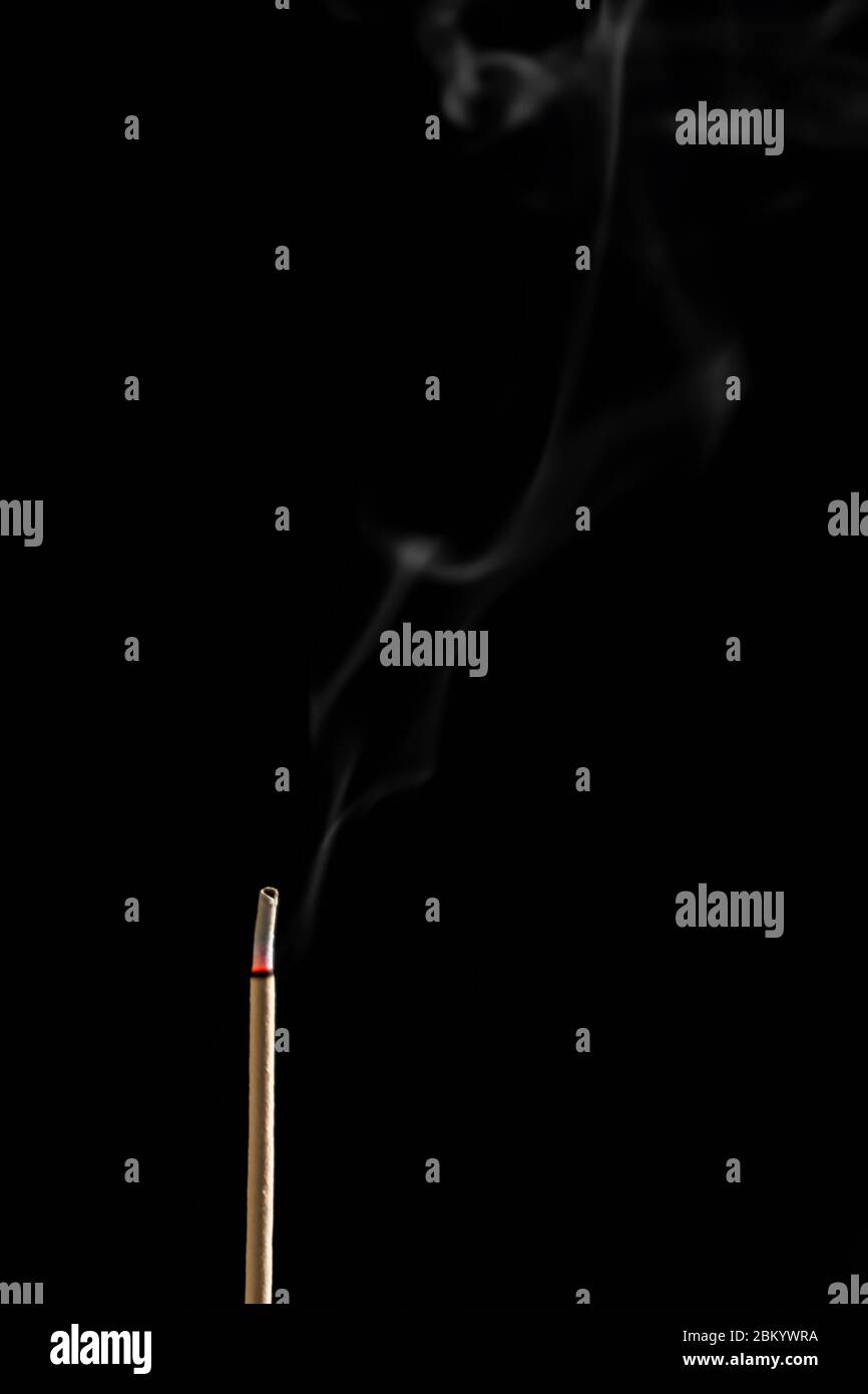 Incense sticks and incense stick smoke on black backgrond with white