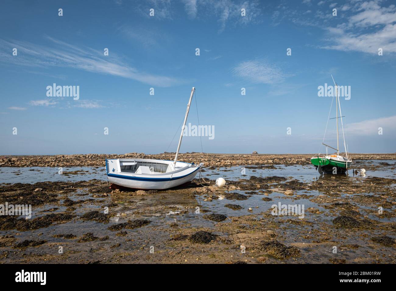 August 03, 2019, Côte d'Armor, Brittany, France-Boats on the sand at low tide in Brittany. Stock Photo