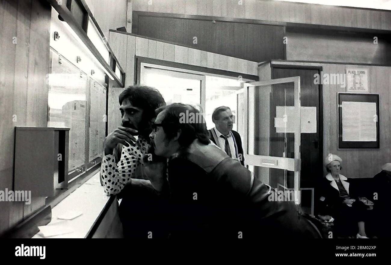 Archive photo. People consider their bets in a betting office or